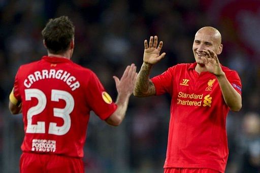 Liverpool&#039;s midfielder Jonjo Shelvey (R) celebrates with teammate Jamie Carragher