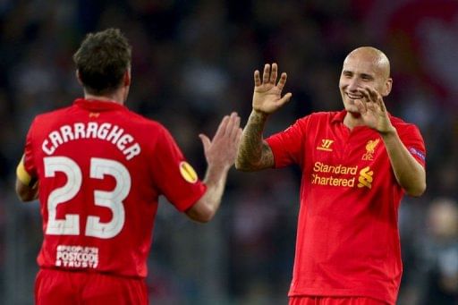 Liverpool&#039;s midfielder Jonjo Shelvey (R) celebrates with teammate Jamie Carragher