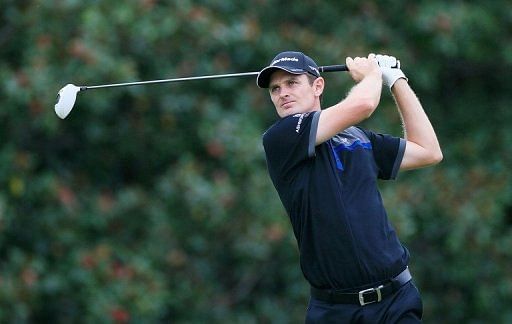 Justin Rose of England watches his tee shot on the fifth hole