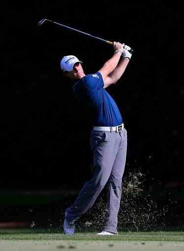 Rory McIlroy of Northern Ireland watches his approach shot on the 16th hole