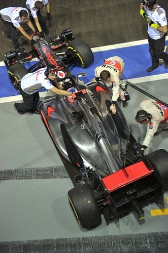McLaren-Mercedes&#039; British driver Jenson Button&#039;s formula one race car rolls in for a pit stop