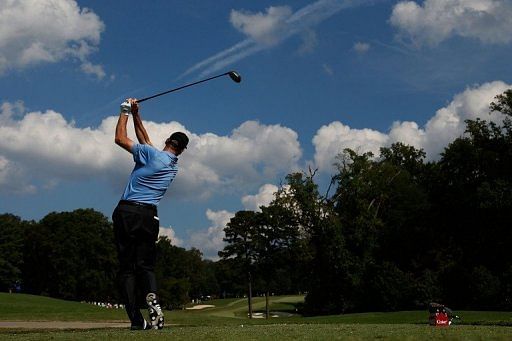 Jim Furyk watches his tee shot on the 15th hole