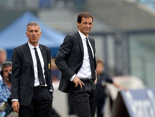 AC Milan&#039;s coach Massimiliano Allegri (R) grimaces next to his assistant Mauro Tassotti