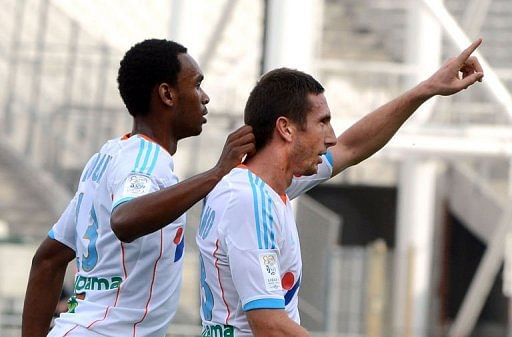 Marseille&#039;s Morgan Amalfitano (R) celebrates with Julio Nkoulou