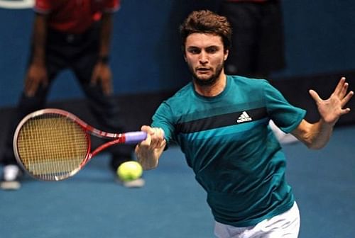 Gilles Simon of France plays a shot against Go Soeda of Japan