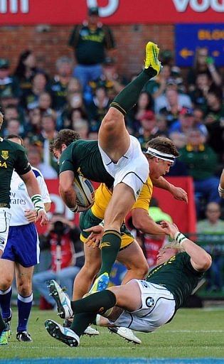 South Africa&#039;s Jean de Villiers is tackled by Australian player