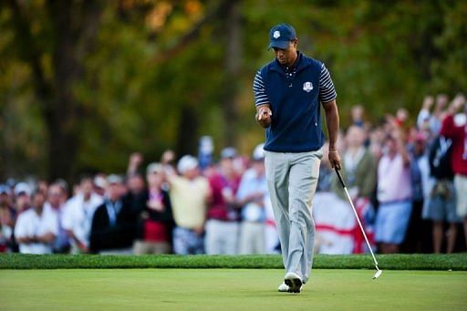 Tiger Woods of the US celebrates after sinking a birdie putt on the 16th green