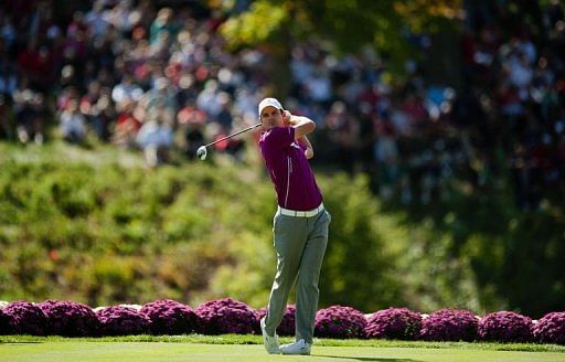 Justin Rose of England tees off from the 18th