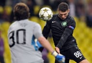 Celtic's Gary Hooper (R) heads the ball as Spartak's Moskva goalie Sergei Pesyakov (L) tries to stop
