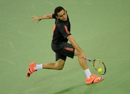 Nicolas Almagro of Spain returns against Tommy Haas of Germany