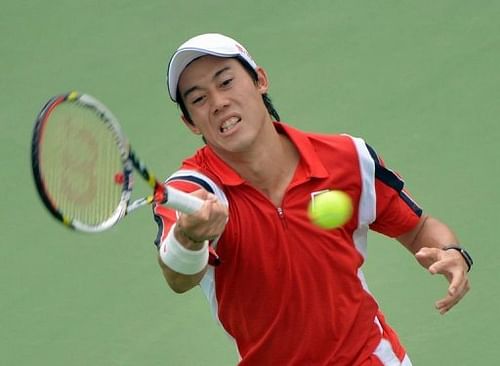 Japan's Kei Nishikori hits a return against China's Wu Di