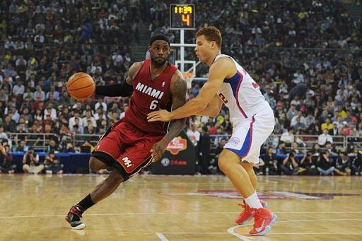 Blake Griffin (R) of the Los Angeles Clippers tries to stop LeBron James of the Miami Heat
