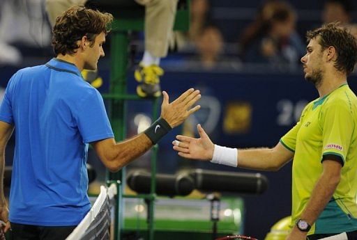 Roger Federer (left) had to dig deep before beating Stanislas Warwinka (right) 4-6, 7-6 (7/4), 6-0