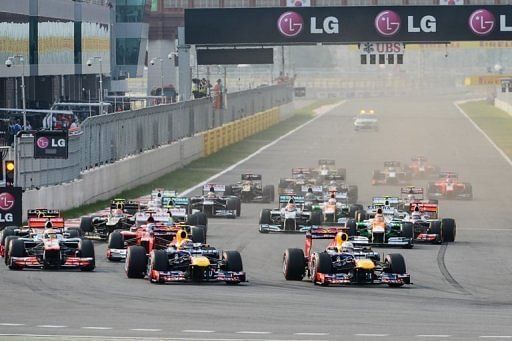 Sebastian Vettel of Germany (right) leads the pack at the start of the race