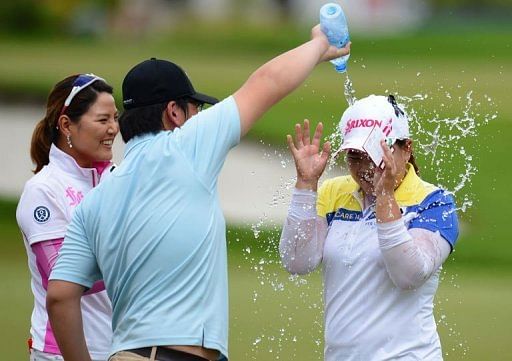 Park Inbee of South Korea is sprayed with water after her victory on the 18th hole of the Sime Darby LPGA Malaysia