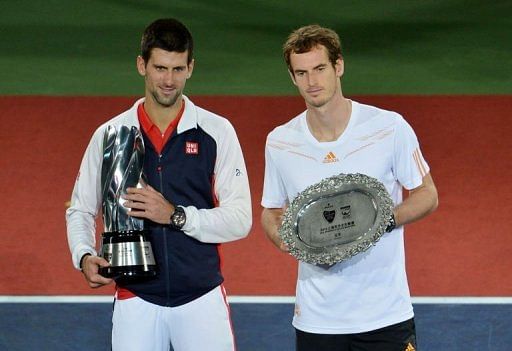 Novak Djokovic (left) with the winners trophy after beating Andy Murray (right) in the Shanghai Masters final