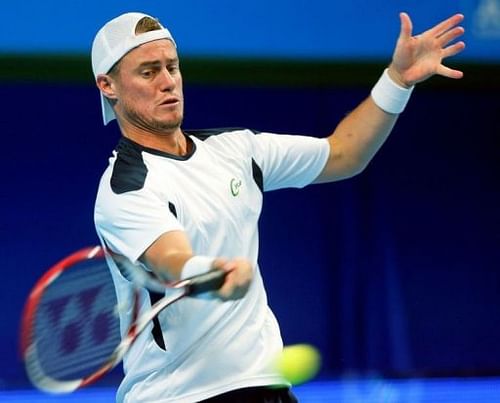 Australia's Lleyton Hewitt returns the ball to Finland's Jarkko Nieminen