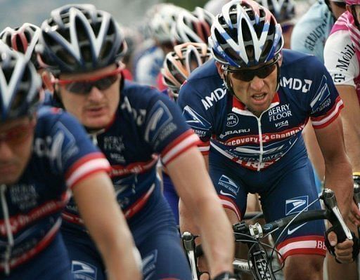 Lance Armstrong rides behind his teammates during the Tour de France in 2004