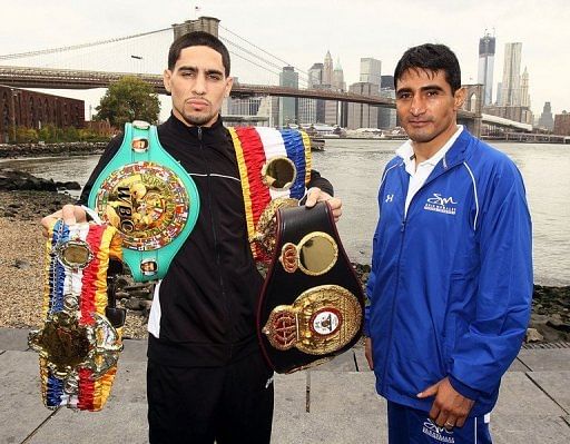 Boxers Danny Garcia (L) and Erik Morales pose during a photo call in front of the Brooklyn Bridge