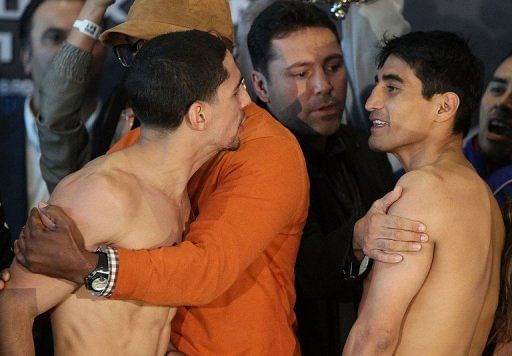 (L-R) Boxers Danny Garcia and Erik Morales exchange words during their weigh in