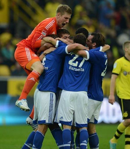 Schalke&#039;s goalkeeper Lars Unnerstall (L) and his teammates celebrate