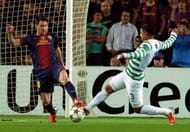 Barcelona's Lionel Messi (L) vies with Celtic's Emilio Izaguirre