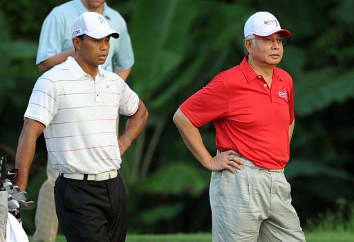 Tiger Woods, left, drew large crowds in his pro-am round with Malaysian Prime Minister Najib Razak