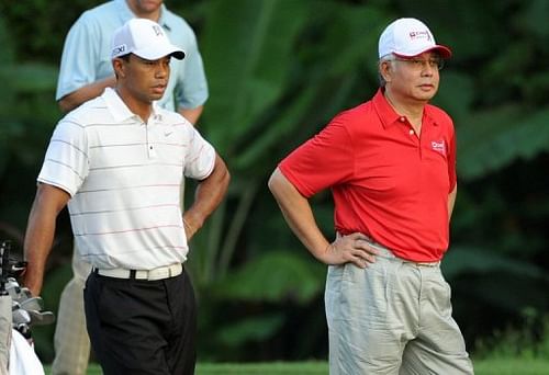 Tiger Woods, left, drew large crowds in his pro-am round with Malaysian Prime Minister Najib Razak