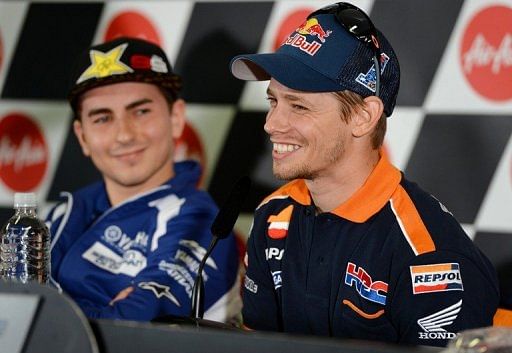 Casey Stoner (R) is recovering from serious right leg injuries in a crash in August