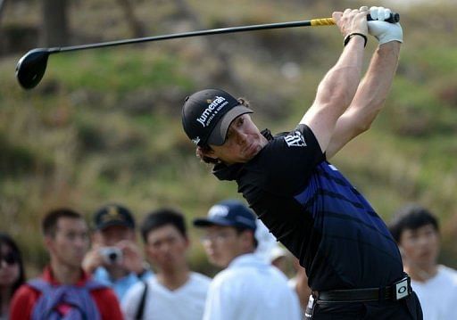 Rory McIlroy of Northern Ireland tees off on the eighth hole in Shanghai