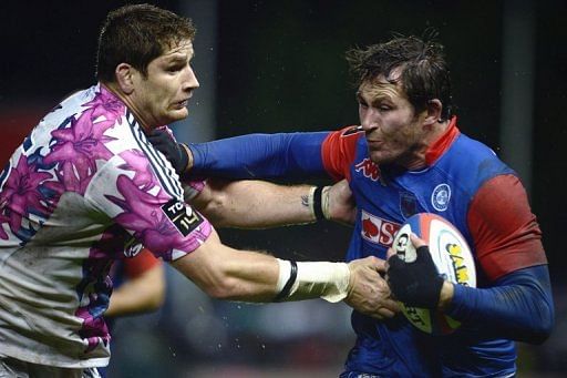 Stade Francais lock Pascal Pape (left) tackles Grenoble flanker Shaun Sowerby during a French Top 14 match in August