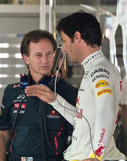 Red Bull-Renault driver Mark Webber (R) talks with team principal Christian Horner