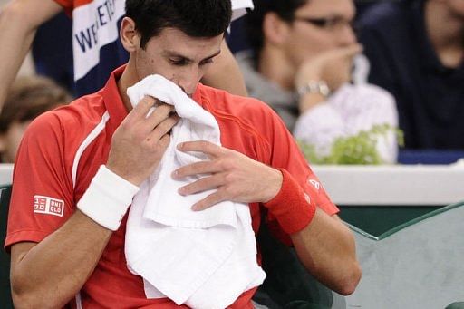 Novak Djokovic reacts after being defeated by Sam Querrey