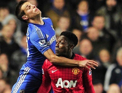 Manchester United striker Danny Welbeck (R) is outjumped by Chelsea defender Cesar Azpilicueta