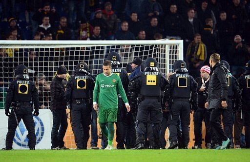 Police secure the inside of stadium in Hanover as fans of Dresden try to storm the pitch on October 31