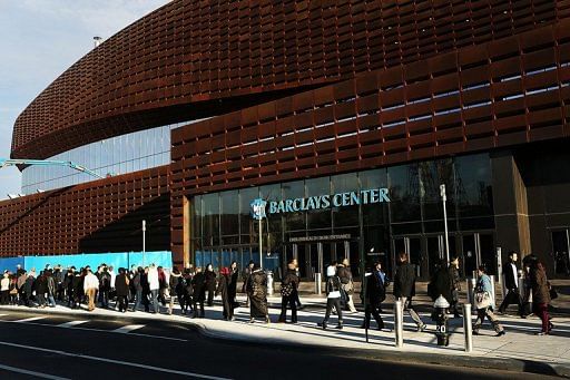 Thousands of people wait to board city buses into Manhattan at the newly opened Barclay&#039;s Center in Brooklyn