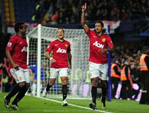Manchester United&#039;s Portuguese midfielder Nani (R) celebrates scoring their third goal against Chelsea