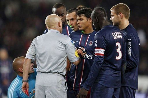French referee Laurent Duhamel (2ndL) gives a red card to Paris Saint-Germain&#039;s forward Zlatan Ibrahimovic (C)