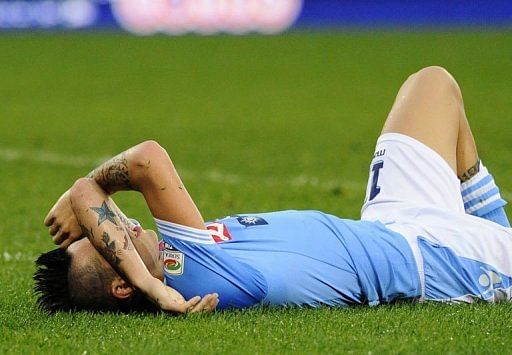 Napoli's Marek Hamsik lies on the pitch after the match