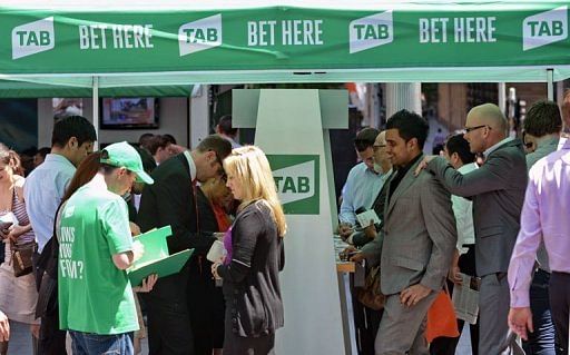 People stand outside a tent set up as a betting booth for the Melbourne Cup horse race in Sydn