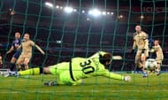 Paris Saint-Germain's Alex Costa (L) scores despite Dinamo Zagreb's goalkeeper Ivan Kelava