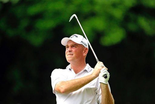 Thomas Bjorn of Denmark hits a shot on day one of the Singapore Open