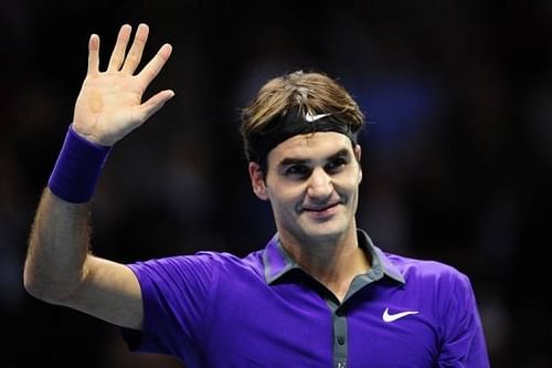 Switzerland's Roger Federer waves as he celebrates beating Spain's David Ferrer in their group B singles match in London