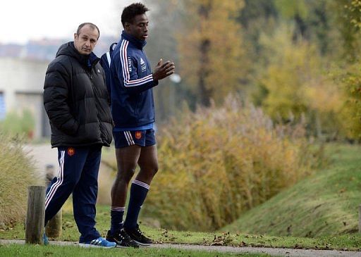 France&#039;s rugby union national team head coach Philippe Saint Andre walks with flanker Fulgence Ouedraogo (R)