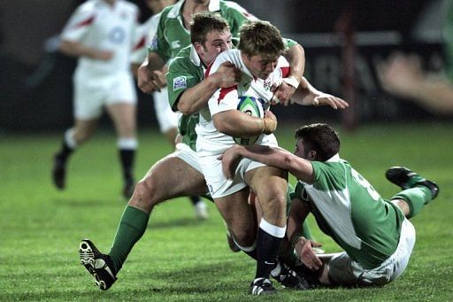 England&#039;s Tom Youngs gets tacked by Ireland&#039;s Kevin Sheahan (on the ground) and David Pollock in 2006