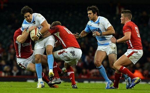 Argentina&#039;s Horacia Agulla (2nd L) is tackled by Wales players at the Millennium Stadium