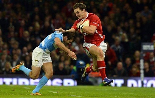 Wales&#039; wing George North (R) hands off Argentina&#039;s wing Gonzalo Camacho