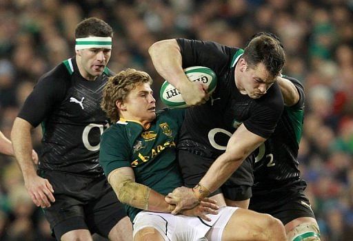 Ireland&#039;s prop Cian Healy (R) is tackled by South Africa&#039;s fly half Pat Lambie (2nd L)