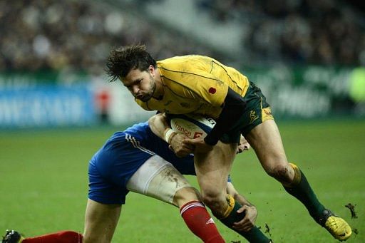 Australia&#039;s wing Adam Ashley-Cooper (R) is tackled by France&#039;s scrum half Morgan Parra