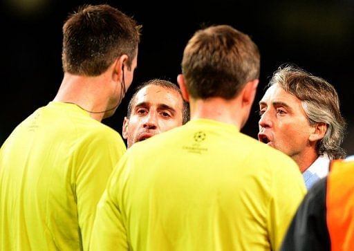 Roberto Mancini confronts the referee on the pitch at the end of the City&#039;s draw  with Ajax on Tuesday